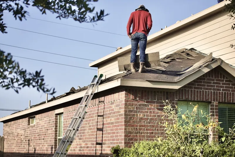 Professional roofer working on a residential roof in Waveland